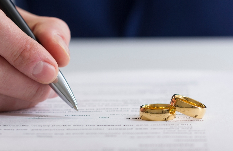 man is signing document