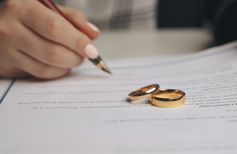 woman is signing prenuptial agreement