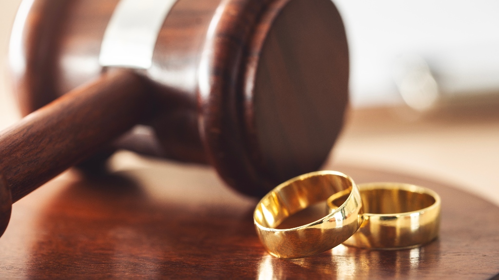 Judge's gavel and wedding rings