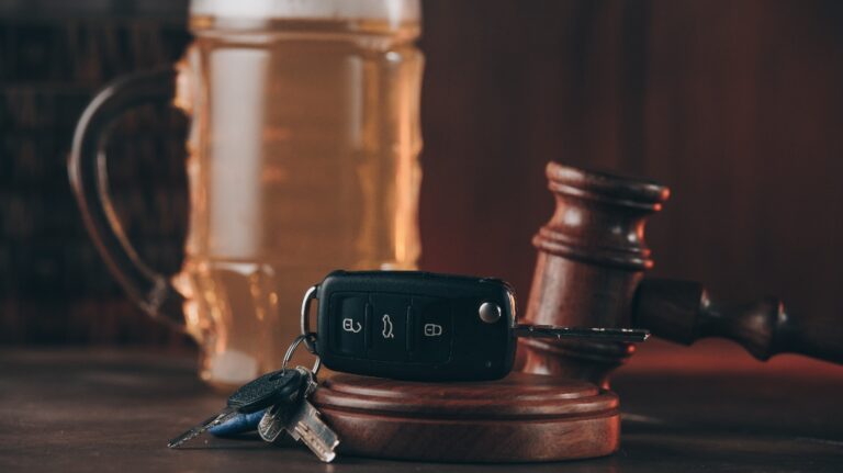 Glass of beer, car keys and judge gavel