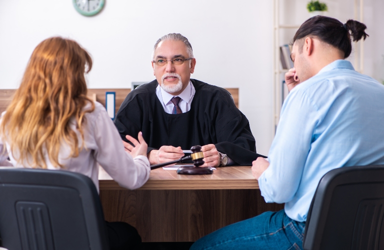 Young couple in the courthouse in divorce concept